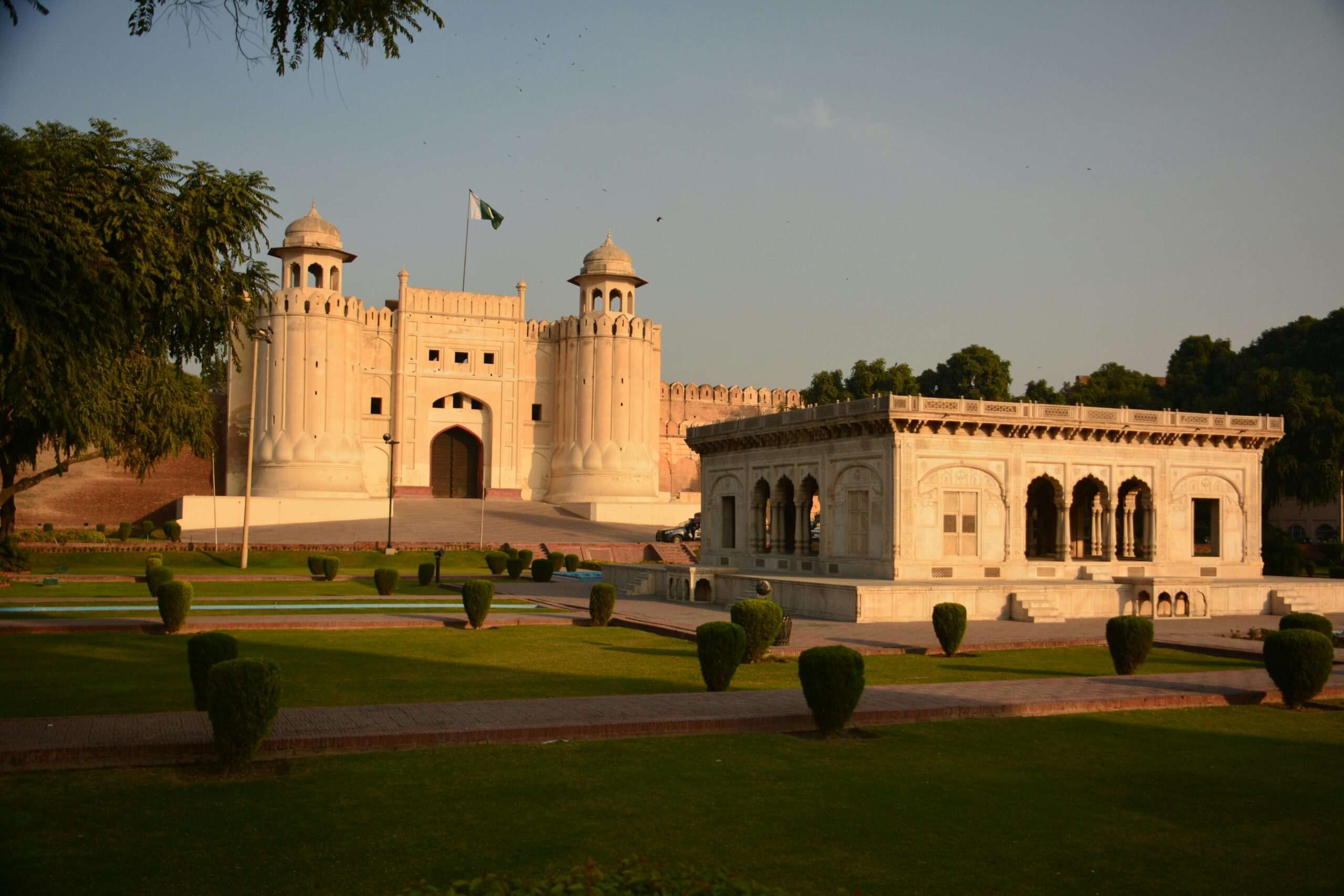 Lahore Fort with its historic Mughal architecture and beautifully maintained gardens at sunset.